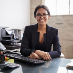 Young professional mixed race woman sitting in an office